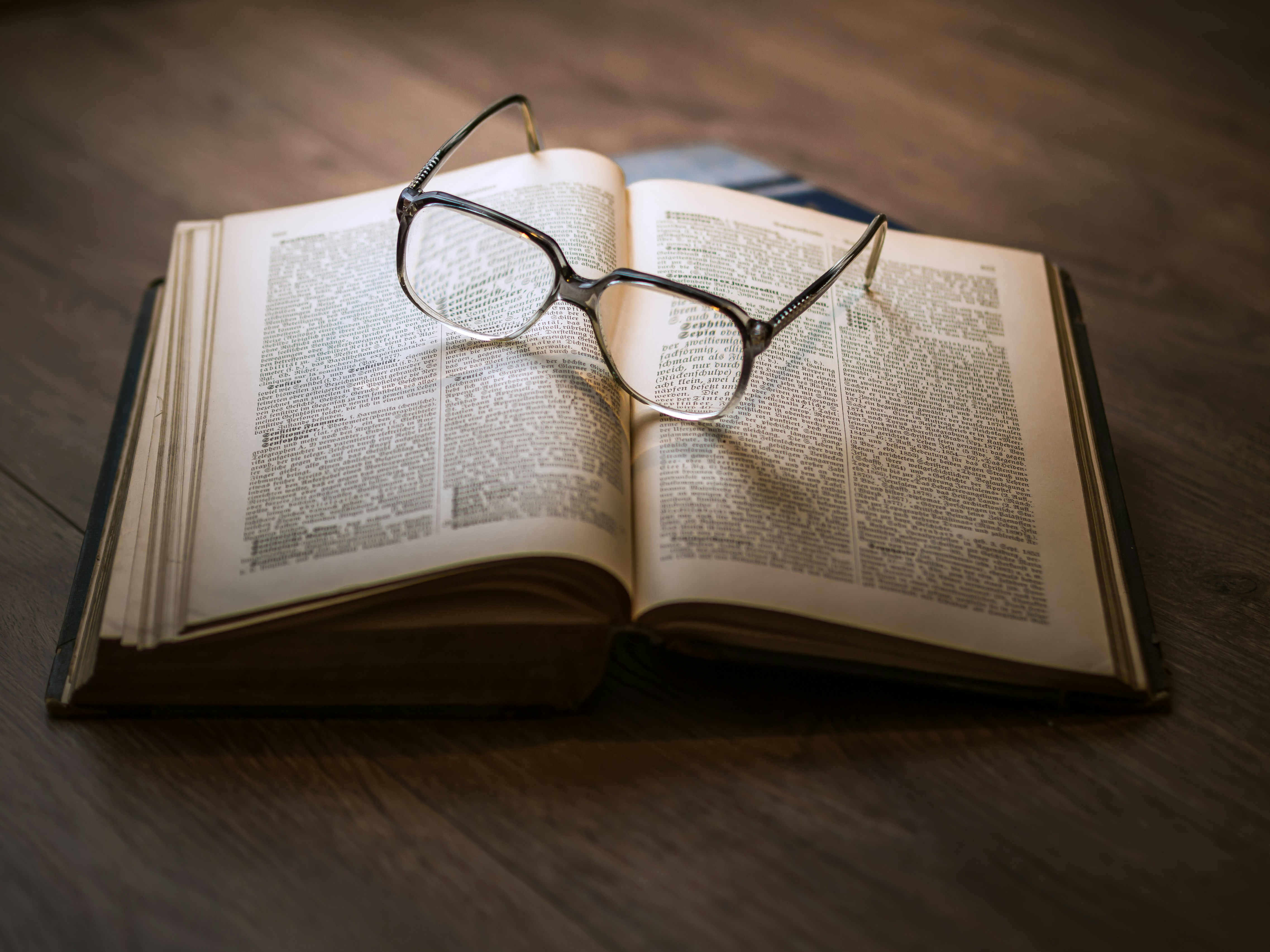 Open reference volume with reading glasses